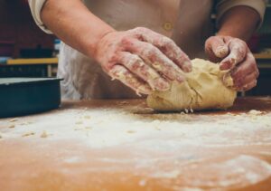 A baker making homemade pie crust dough pastry
