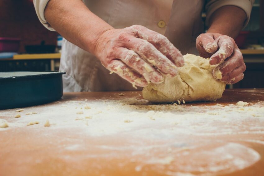 A baker making homemade pie crust dough pastry